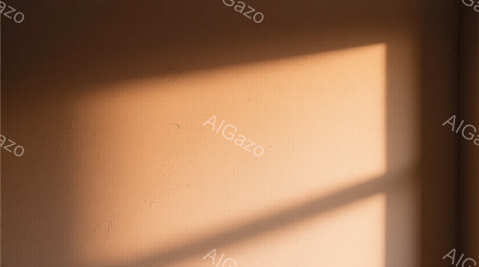 この画像は、明るいオレンジ色の壁に影が映ったシンプルな構図です。壁はわずかにテクスチャがあり、光と影のコントラストによって温かみのある雰囲気が生み出されています。影の形状は不明瞭で、何らかの物体によって生み出されたものと思われますが、詳細は不明です。