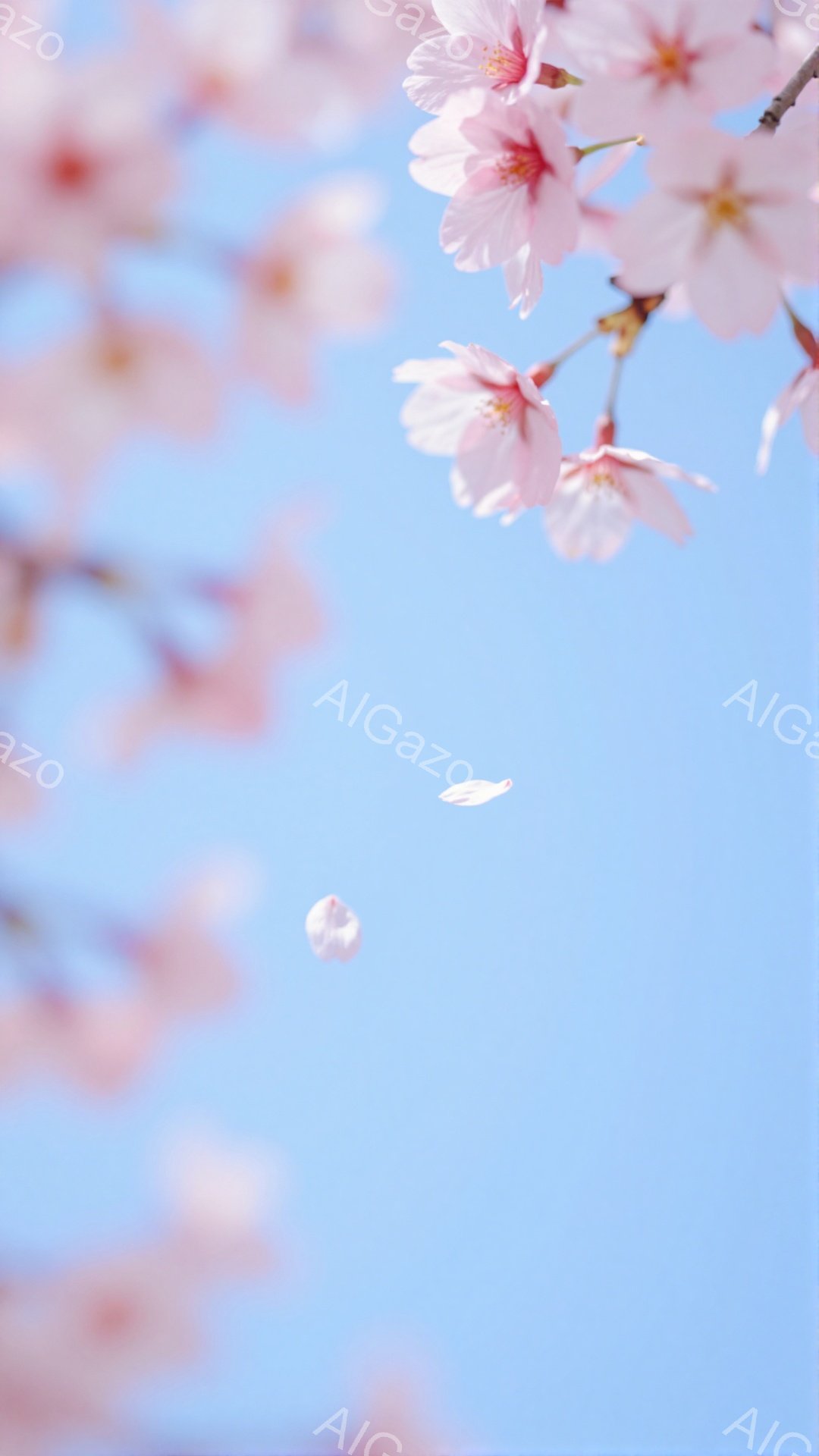 空は明るい水色で、桜の花びらが舞い散っている様子が捉えられています。 桜の枝が画面の左側に配置され、ピンク色の美しい花が咲き誇っています。 全体的に春の暖かさと儚さを感じさせる、優しい雰囲気の写真です - AI生成フリー素材