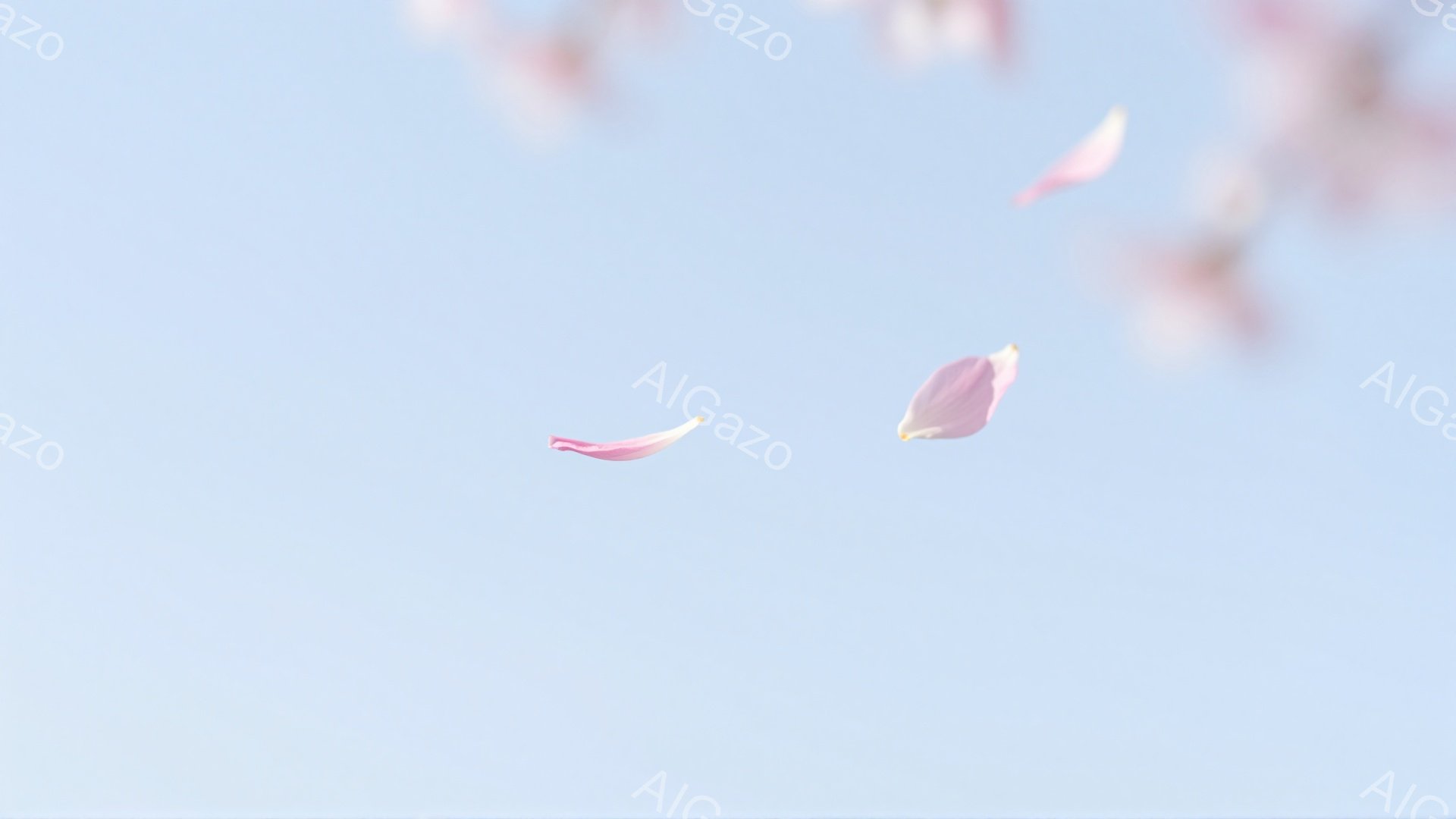 穏やかな空を舞う、数枚の桜の花びらが印象的な写真です。淡いピンク色の花びらが、空の青さの中で優雅に漂い、春の暖かさと儚さを表現しています。背景は空のみで、花びらの繊細さが際立っています。