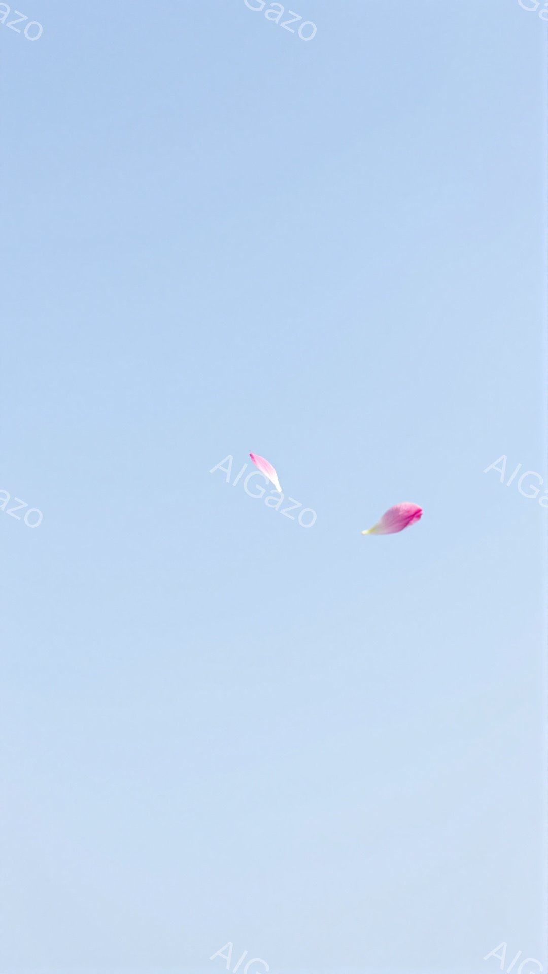 空は明るい青色で、二つの薄いピンク色の花びらが、まるで空を舞っているかのように漂っている。花びらは、一つは上の方に、もう一つは少し下の方に位置しており、その鮮やかな色が、空の青さと対照的である。全体的に、穏やかで詩的な雰囲気を感じさせる。