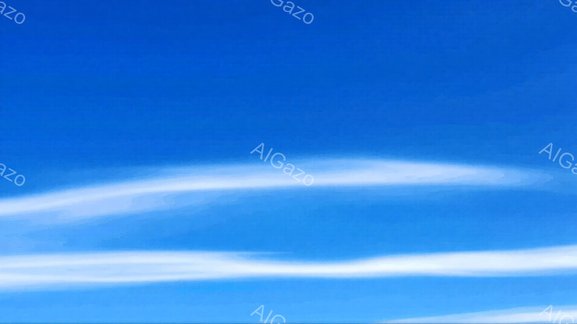 広大な青空に、白い筋状の雲が横に長く広がっています。雲は細く、まるで筆で描いたような繊細なラインを描いています。晴れ渡った空と白い雲のコントラストが、爽やかで開放的な雰囲気を醸し出しています。