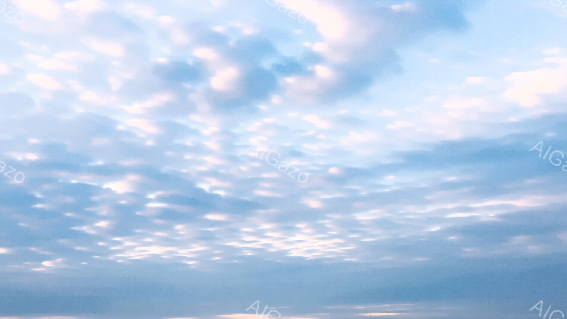 空一面に白い雲が広がっており、まるで羊の群れのような形をしています。地平線には薄いオレンジ色の光が見え、夕焼けか日の出の時間帯であることを示唆しています。全体的に穏やかで、平和な雰囲気を感じさせる空の風景です。