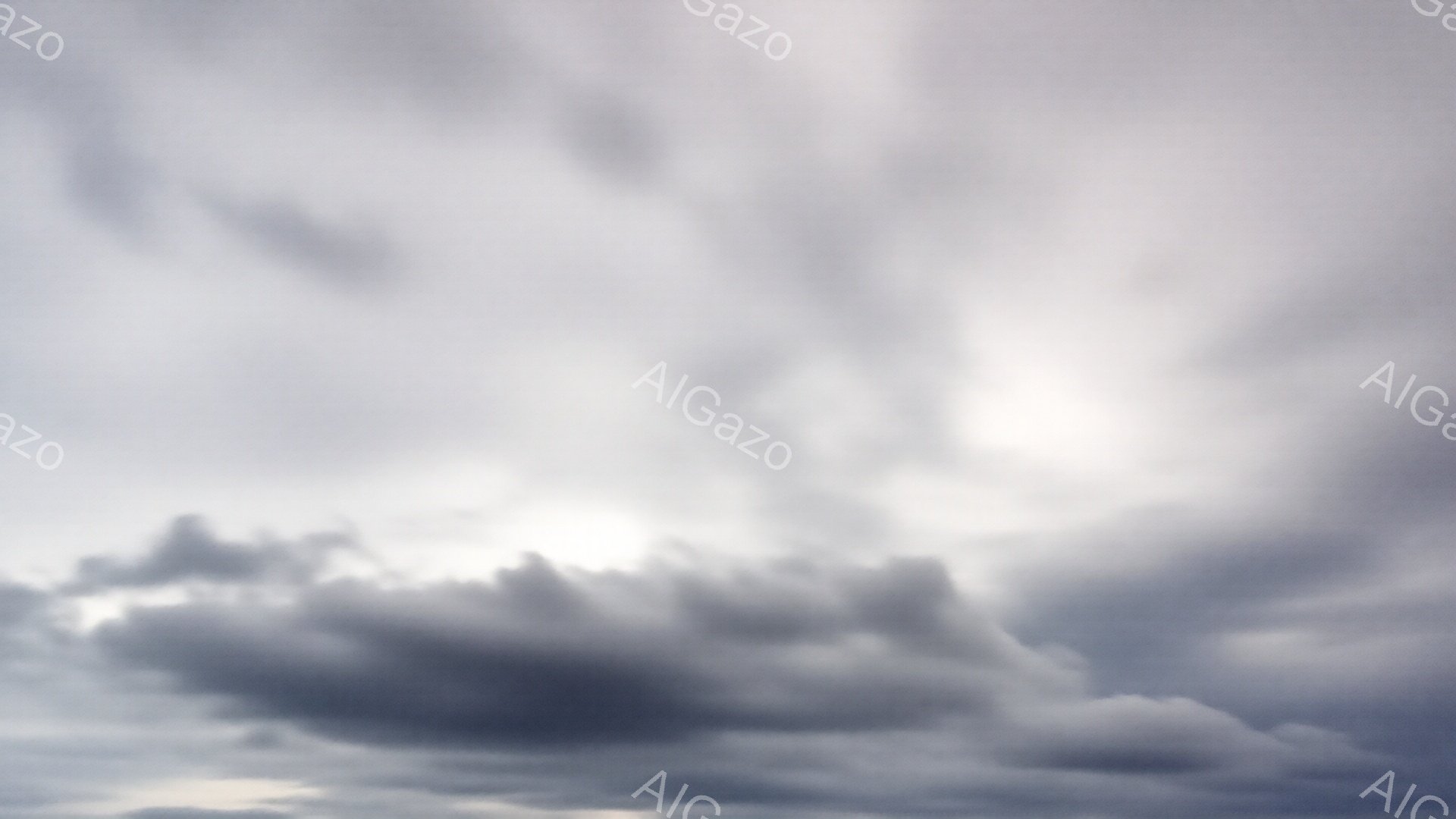 厚い雲が空を覆い、太陽の光がわずかに差し込んでいる様子が描かれています。雲の形は多様で、まるで波のようにうねり、重厚な雰囲気を醸し出しています。光が雲を照らすことで、白とグレーのコントラストが強調され、ドラマチックな天候を表しています。