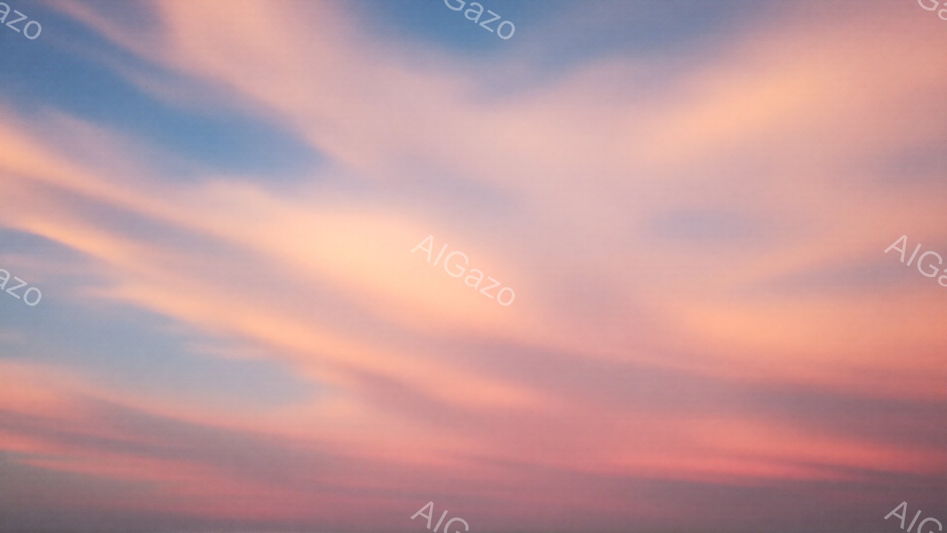 空全体が夕焼けの色合いで染め上げられており、オレンジ、ピンク、薄い青色が混ざり合い、まるで絵の具を水に溶かしたような美しいグラデーションを作り出している。雲はまるで筆で描いたかのように、繊細で流れるような曲線を描き、穏やかで幻想的な雰囲気を醸し出している。この空は、夕暮れ時の静けさと、明日への希望を感じさせる。