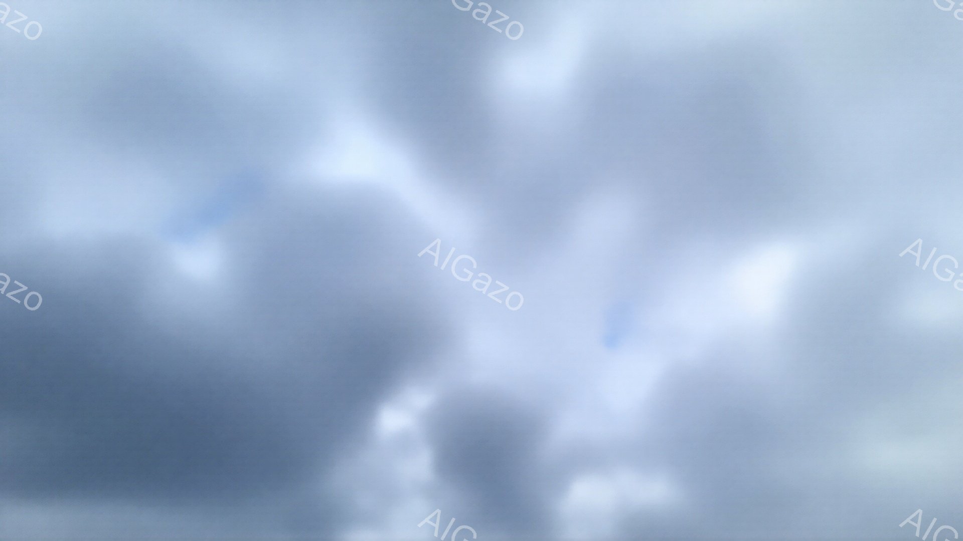 この画像はぼやけており、詳細を正確に識別することは困難です。全体的には、空と雲が広がっているように見え、光が差し込んでいる部分もあり、薄暗く幻想的な雰囲気を醸し出しています。雲の形は抽象的で、明確な輪郭が見えず、まるで水彩画のような印象を与えます。