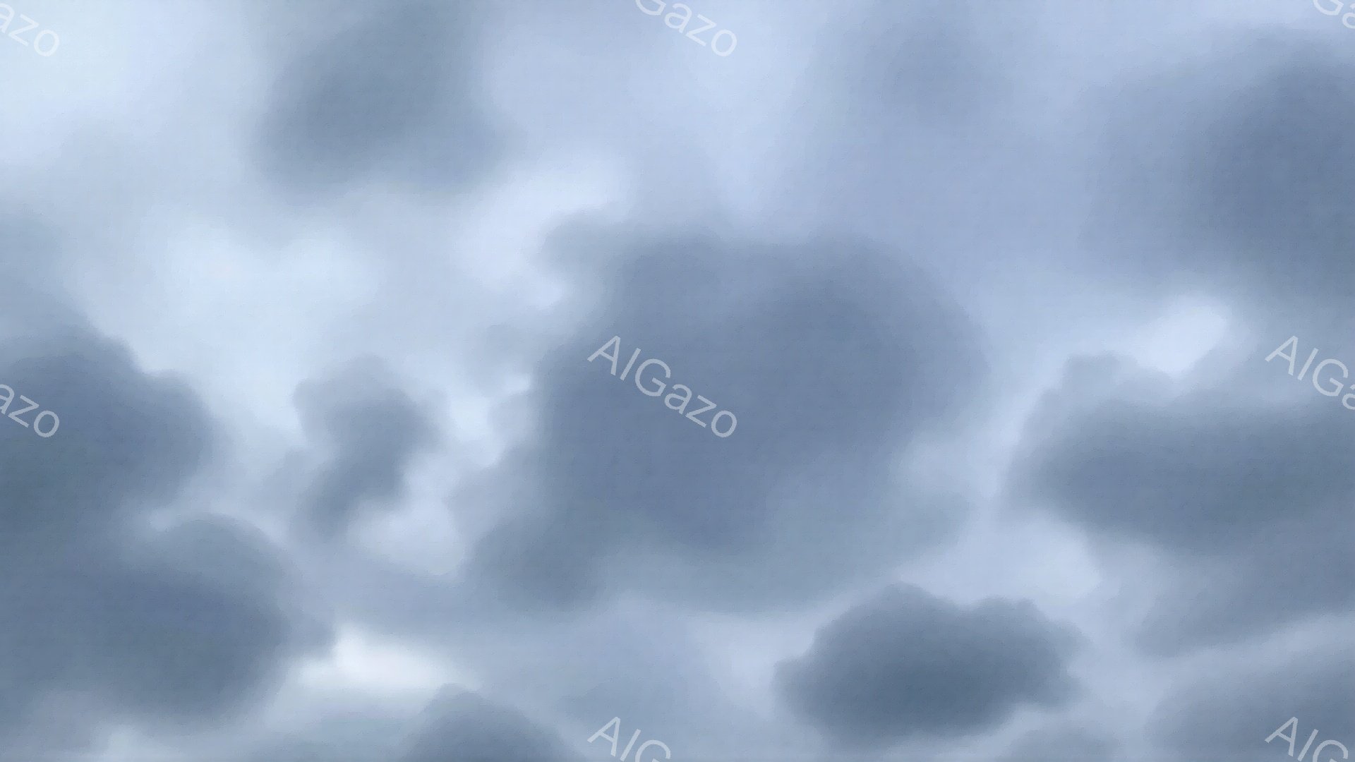 厚い灰色の雲が空を覆い、重苦しい雰囲気を醸し出しています。雲は大きく、丸みを帯びており、まるで押し寄せる波のようです。全体的に陰鬱で、雨が降りそうな、あるいは嵐が近づいているような気配が感じられます。