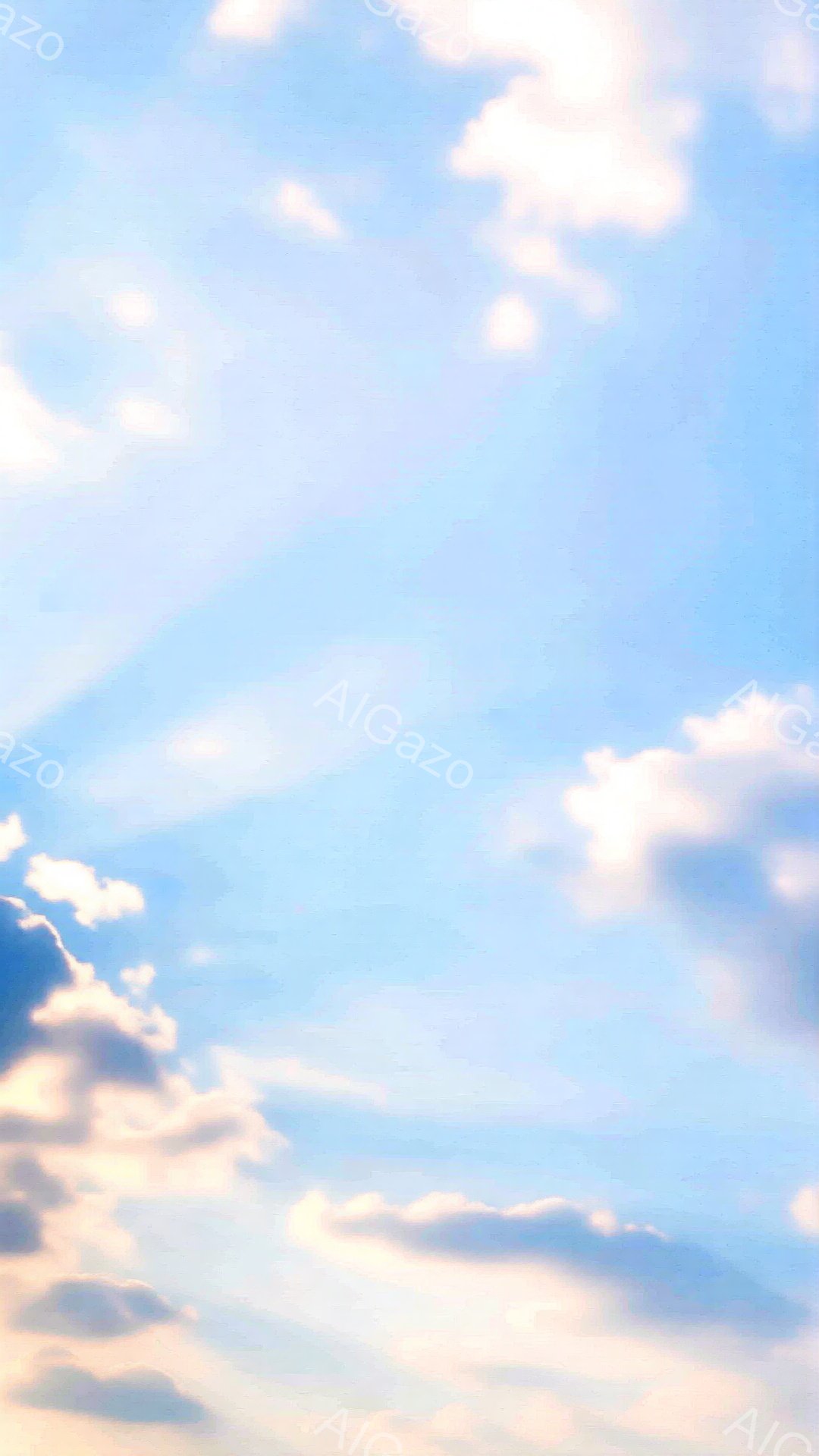 鮮やかな青空に白い雲がふわふわと浮かんでいます。雲は太陽の光を浴びて、ふちに淡いピンク色が広がっており、穏やかで幻想的な雰囲気を醸し出しています。空全体が明るく、平和な印象を与えます。