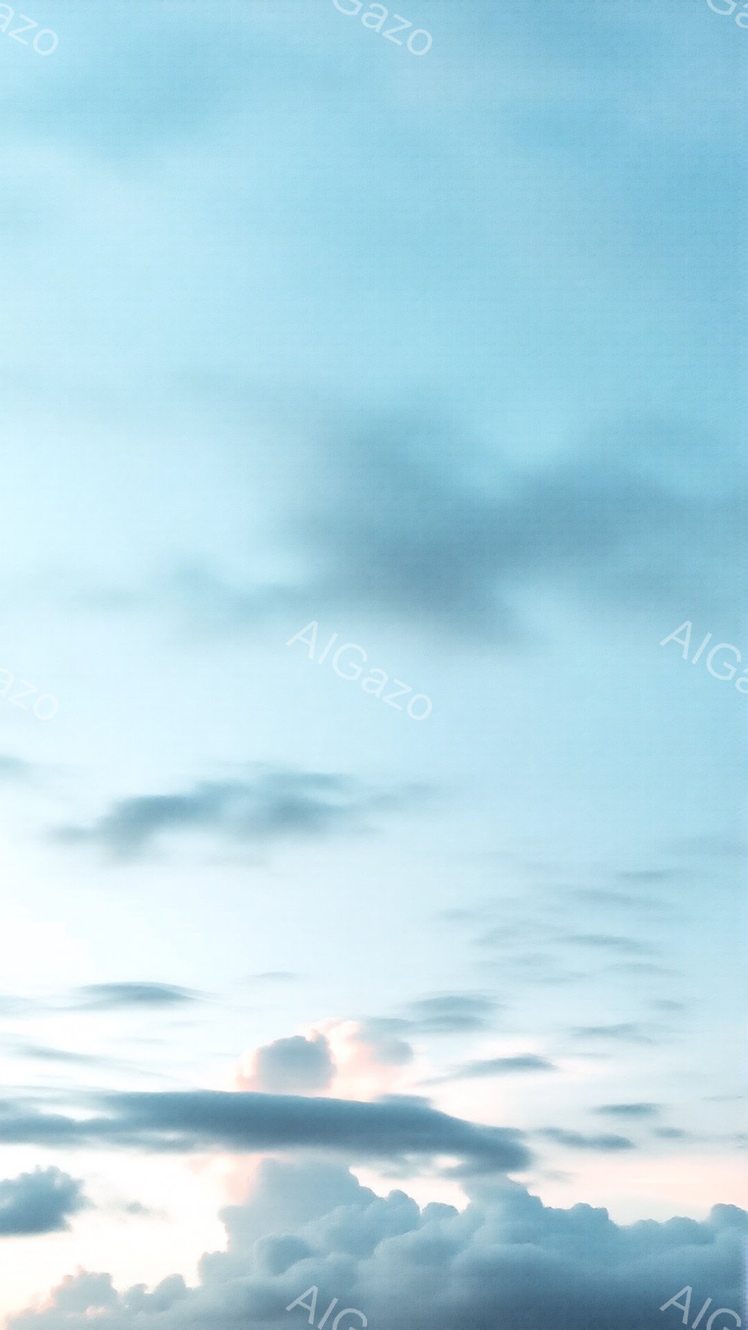 空には、白と灰色の雲が広がり、夕焼けの名残と思われる淡いピンク色の光が雲の下に広がっている。雲の形は多様で、まるで波のように流れているかのような印象を与える。全体的に穏やかで静謐な雰囲気であり、夕暮れ時の空の美しさを捉えた写真である。