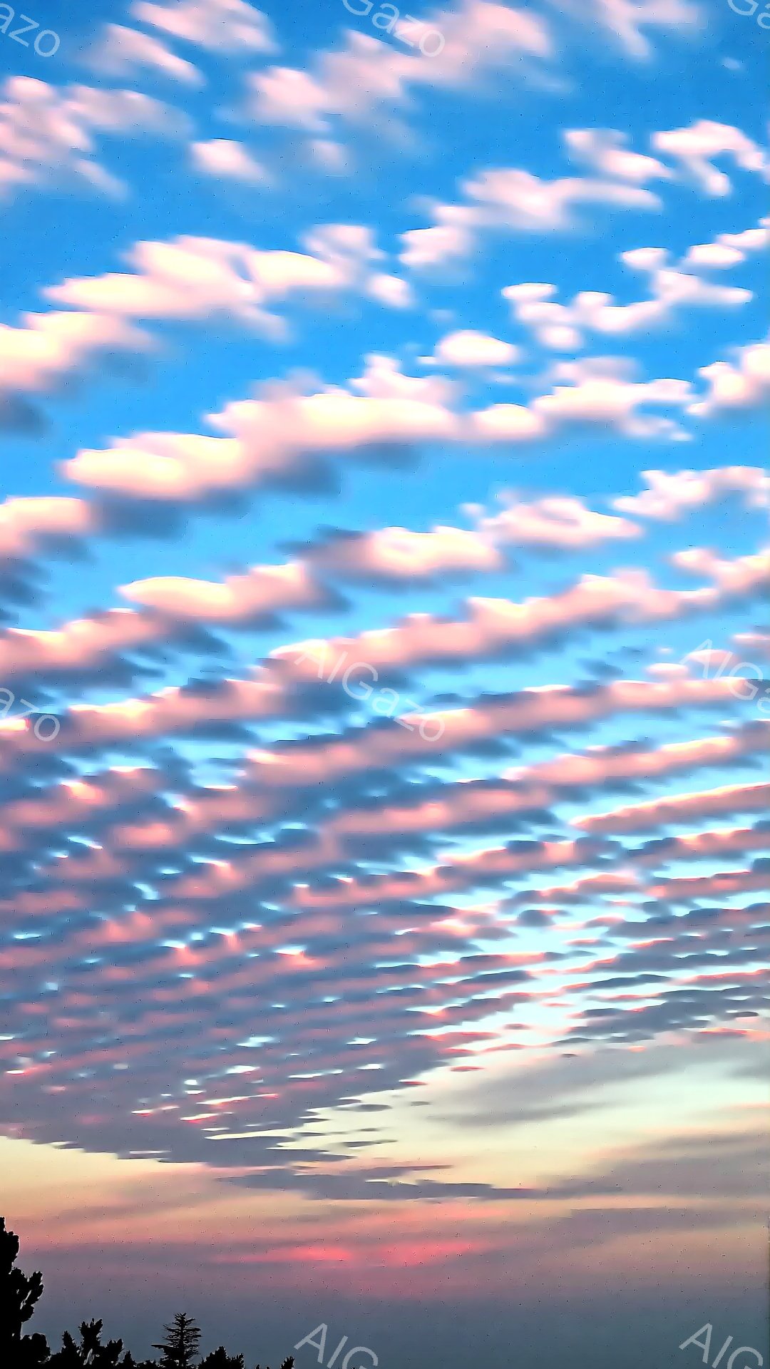 空は鮮やかな青色からピンク色、オレンジ色へと徐々に変化しており、まるで絵の具を混ぜたような美しいグラデーションが広がっている。細い雲が規則的に並び、まるで天に描かれた筆跡のようだ。地平線付近には、緑色 - AI生成フリー素材