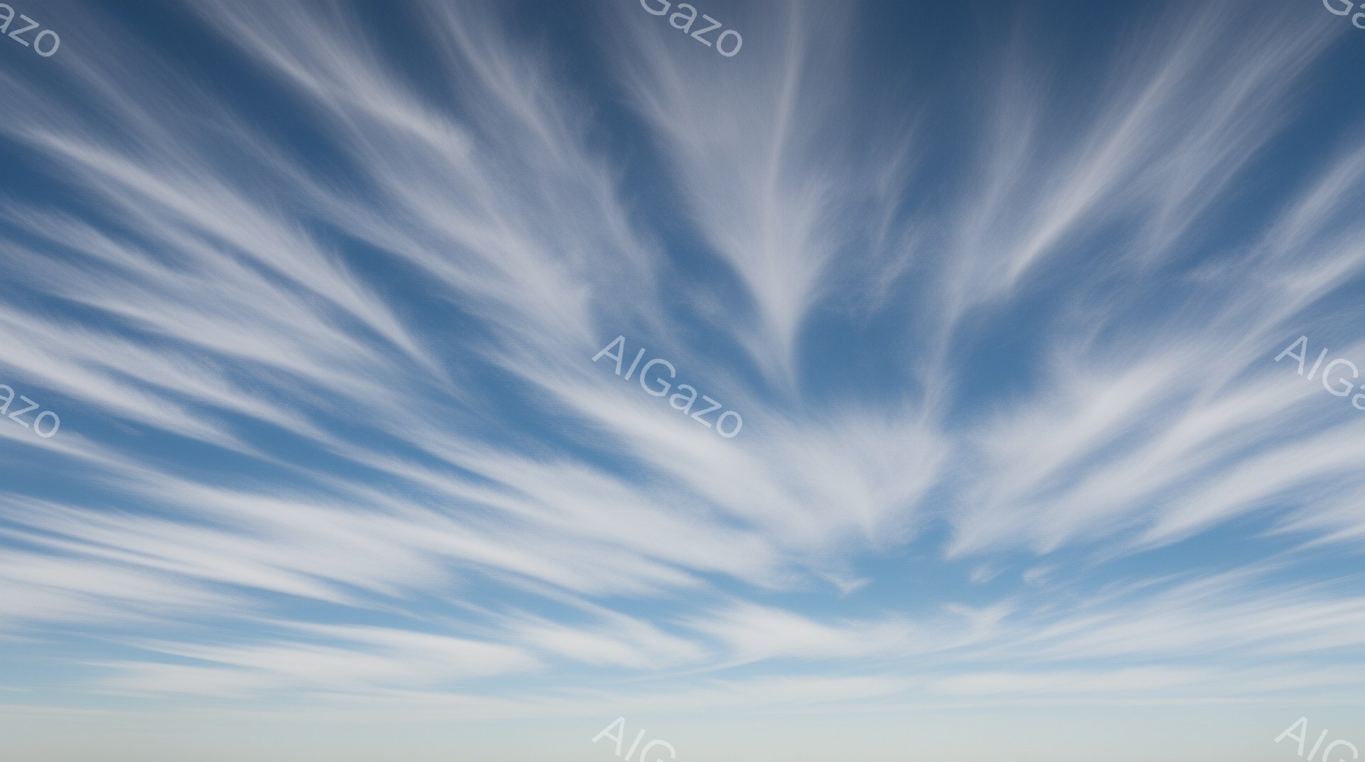 鮮やかな青空に、白い筋状の雲が放射状に広がっている様子が捉えられています。雲はまるで羽毛のように繊細で、空全体に躍動感と広がりを与えています。穏やかな日差しと白い雲のコントラストが、平和で幻想的な雰囲気を醸し出しています。