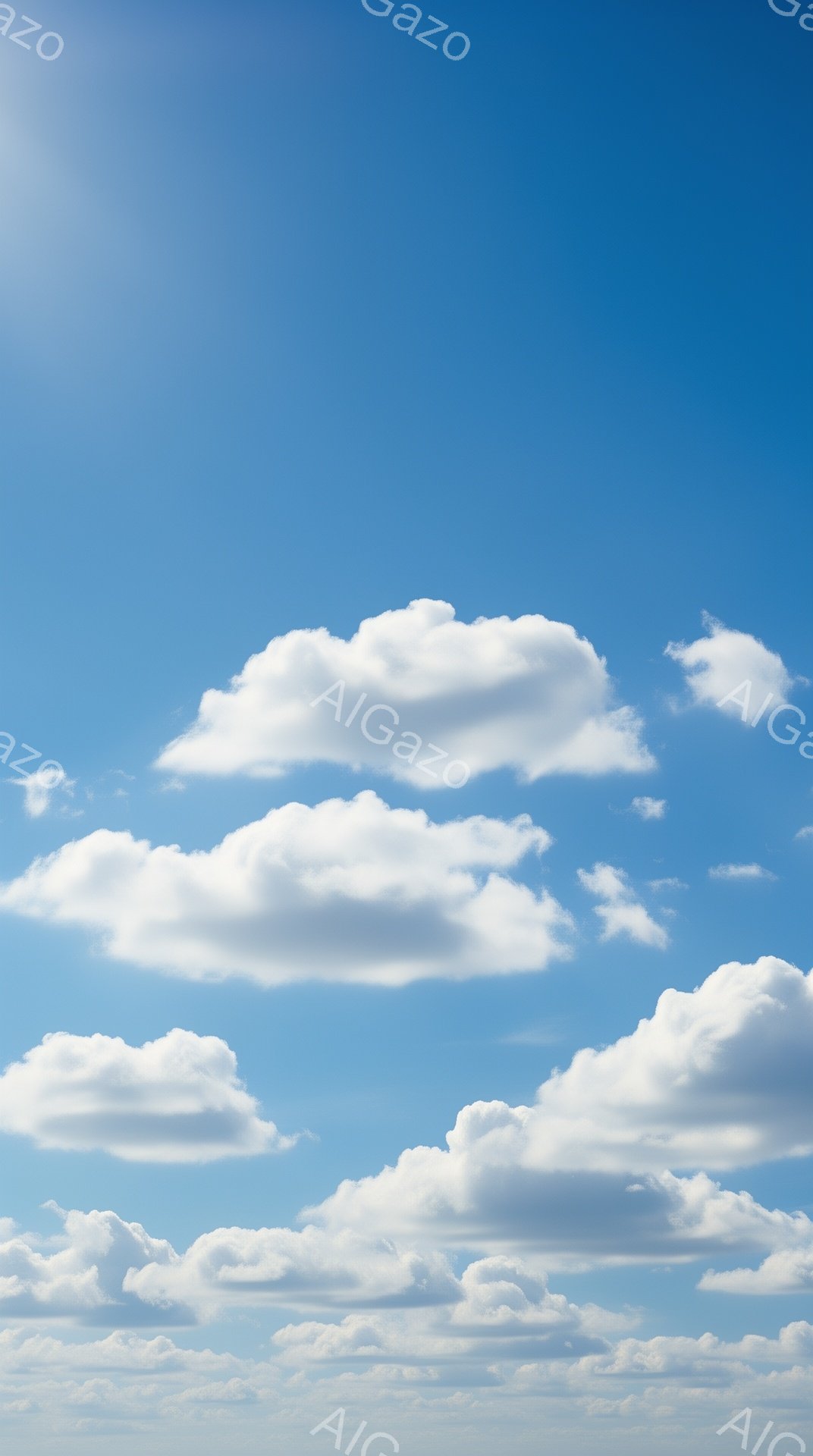 鮮やかな青空に、ふわふわとした白い雲が浮かんでいます。雲は羊の毛のように丸く、ところどころに影がつき、立体感を増しています。穏やかな晴天で、空全体が明るく開放的な雰囲気です。