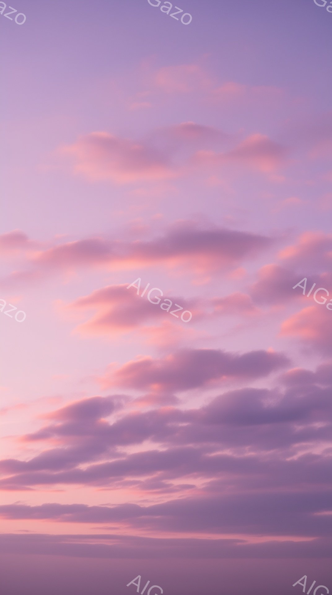 空は鮮やかなピンクと紫色のグラデーションで染め上げられ、雲が水平方向に広がっている。雲は柔らかい綿のように見え、夕焼けまたは日の出の穏やかな光に照らされている。全体的に、夢のような、静かで平和な雰囲気を感じさせる。